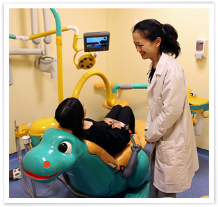 Dr. Selene Wun, Director, Pediatric Residency, Dentistry, caring for patient in pediatric suite at 1775 Grand Concourse Dental Practice.