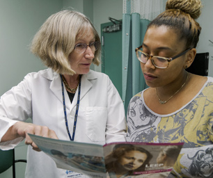 Dr. Harriet Smith, Director, Gynecologic Oncology, instructing patient.