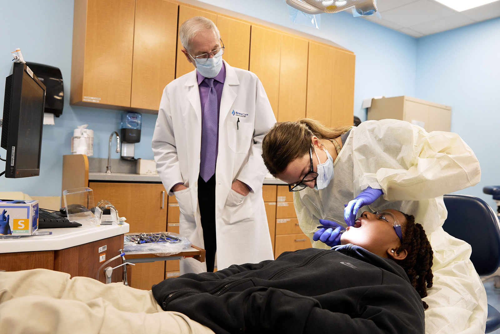 Dr. Peter Antonellis, Orthodontic Residency Program Director, observing Dr. Tara Sheehan, Chief Resident, Orthodontics, examining patient.
