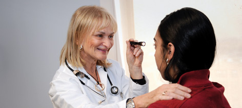 Dr. Rene Elkin, Chief, Division of Neurology, examining patient.