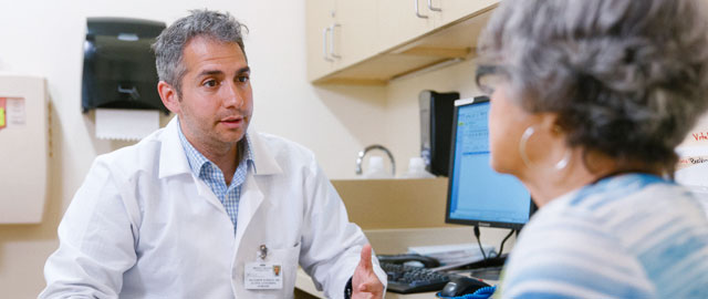 Dr. Matthew Furman, Attending, Surgical Oncology, consulting with patient.