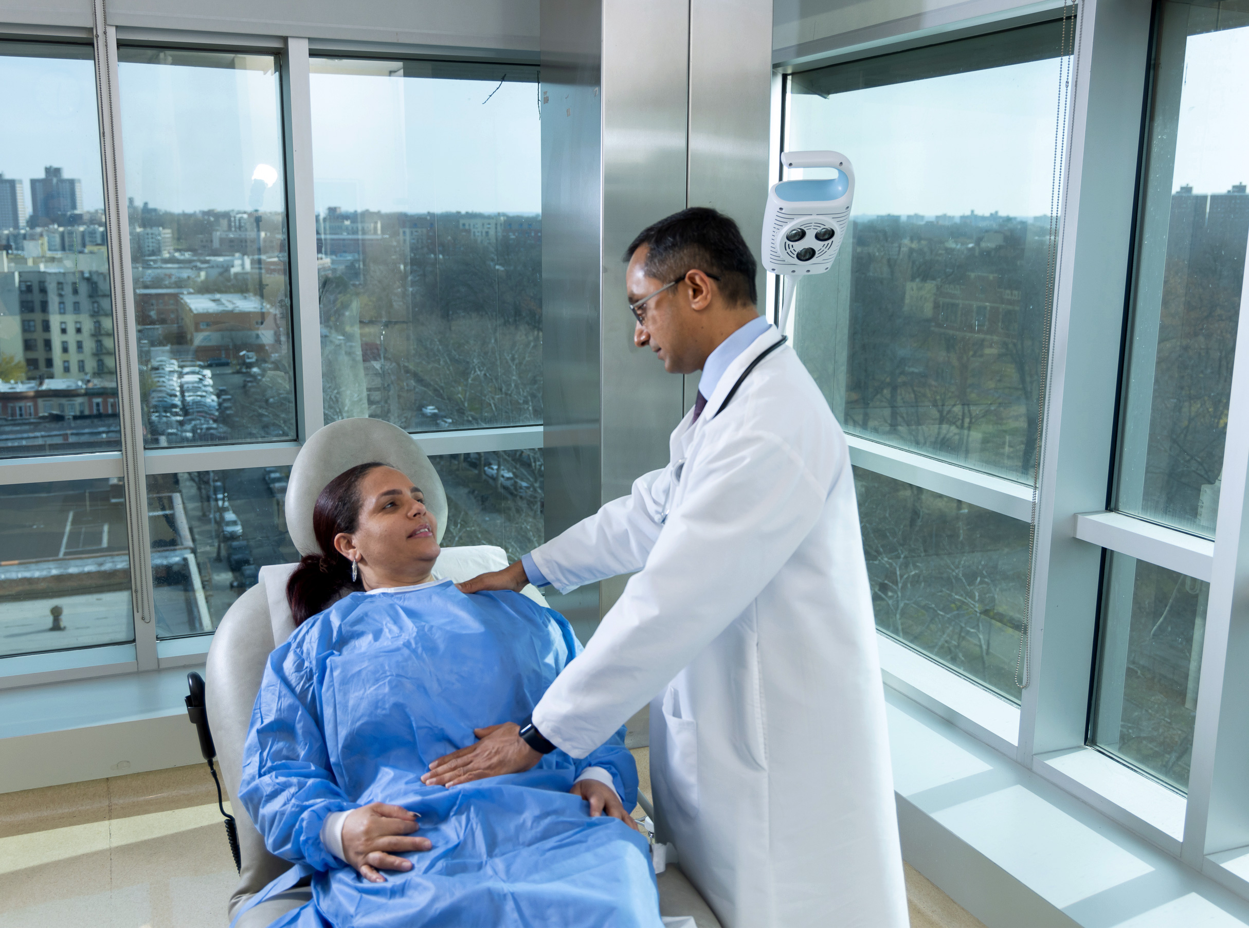 Dr. Vinayak Gowda, Attending, Surgery, examining patient in Surgical Outpatient Suite.