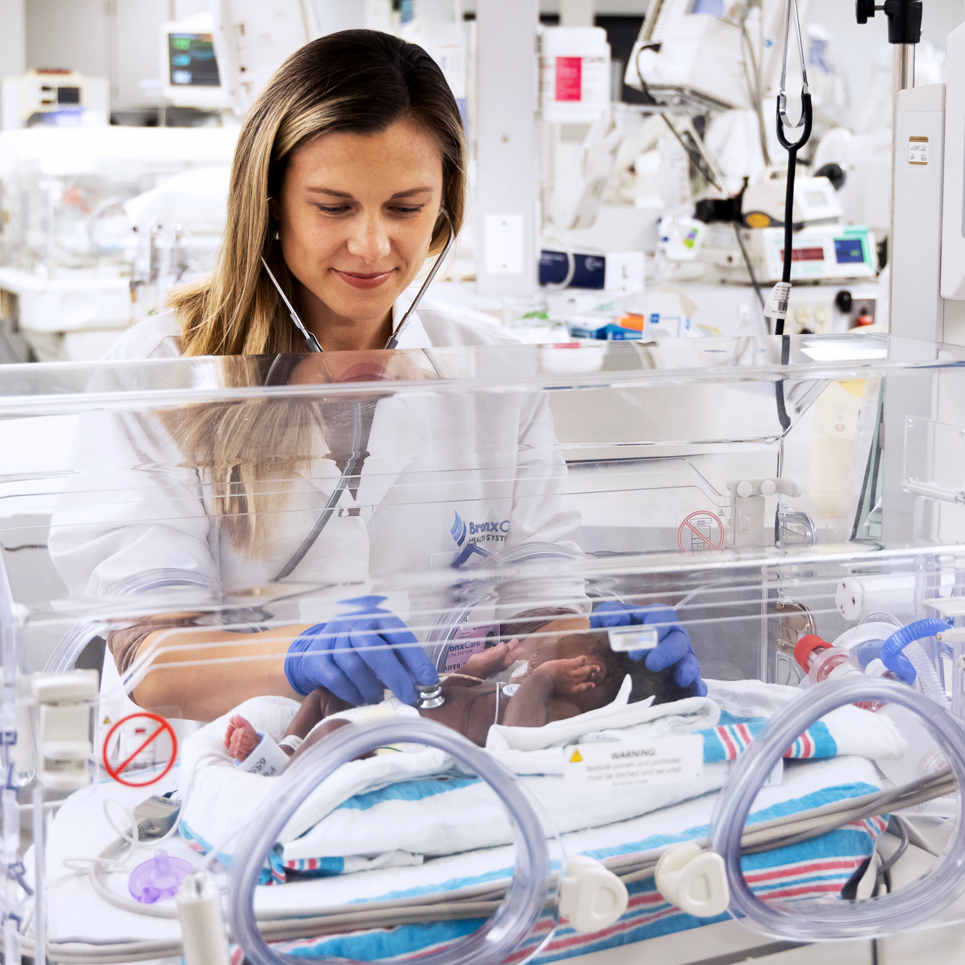 Dr. Jennifer Horne, Attending, Neonatology, examining infant.